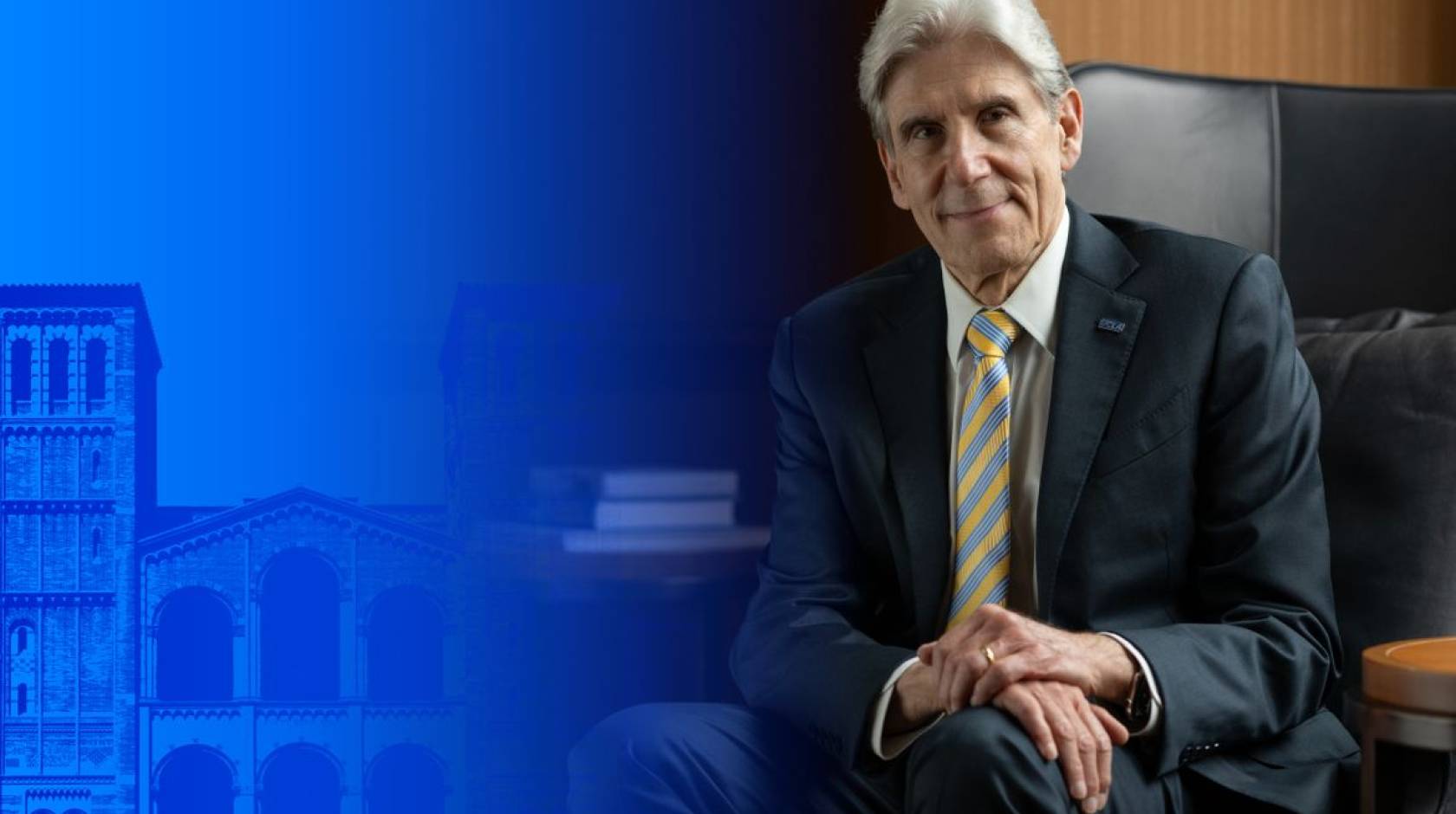 On the left side of the image, UCLA's Royce Hall with a blue layer over it; on the right, a man with a blue and gold tie, white hair, in a suit in a wood-paneled office (Dr. Frenk)