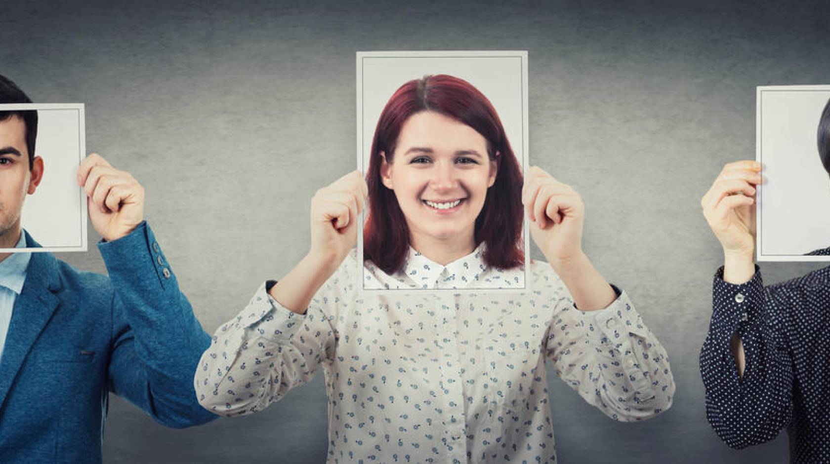 People cover their faces with photos of themselves smiling