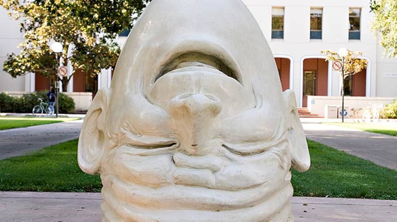 A UC Davis Egghead sculpture - an upside down head sculpture, laughing