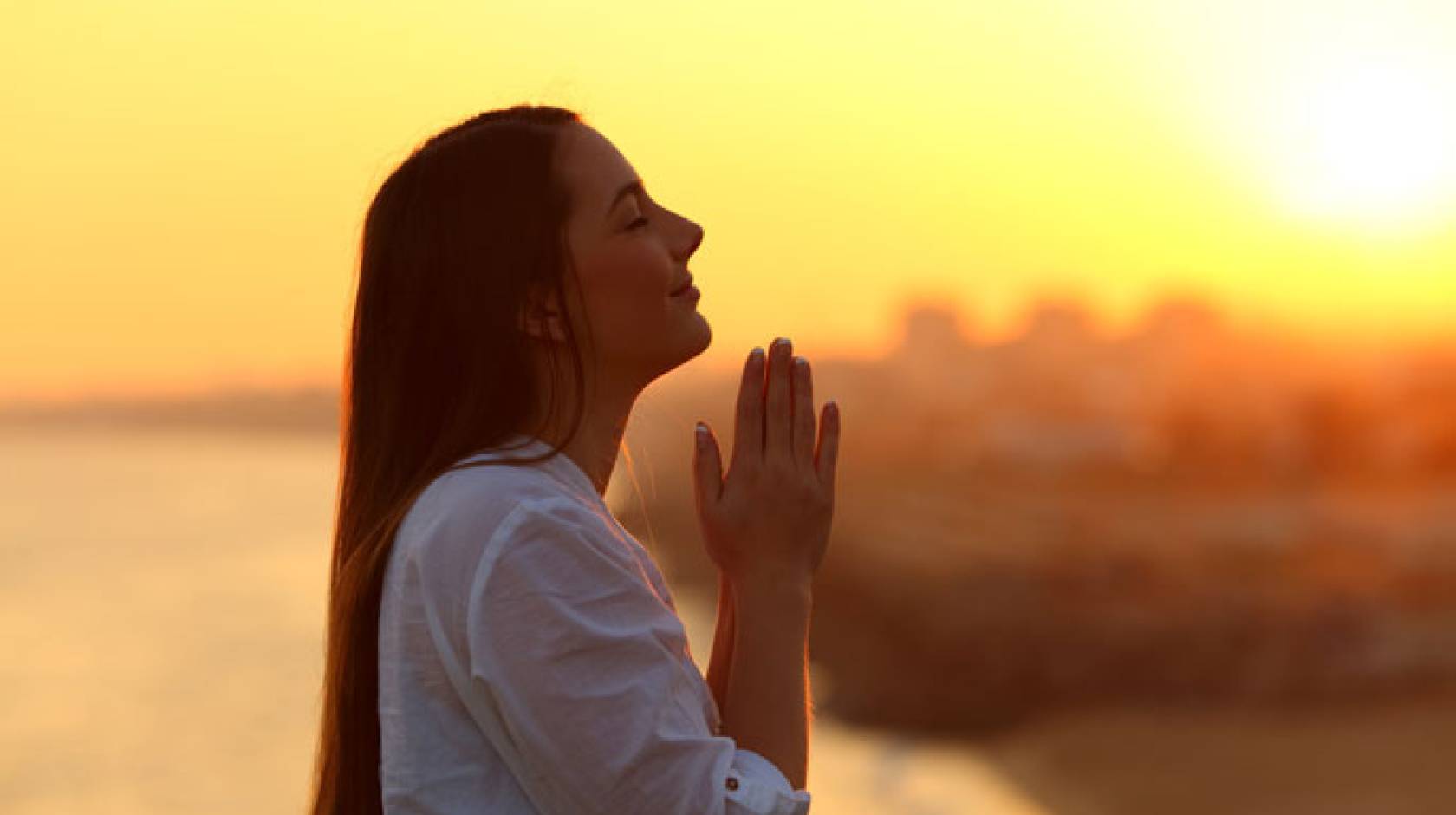 Young woman clasping hands