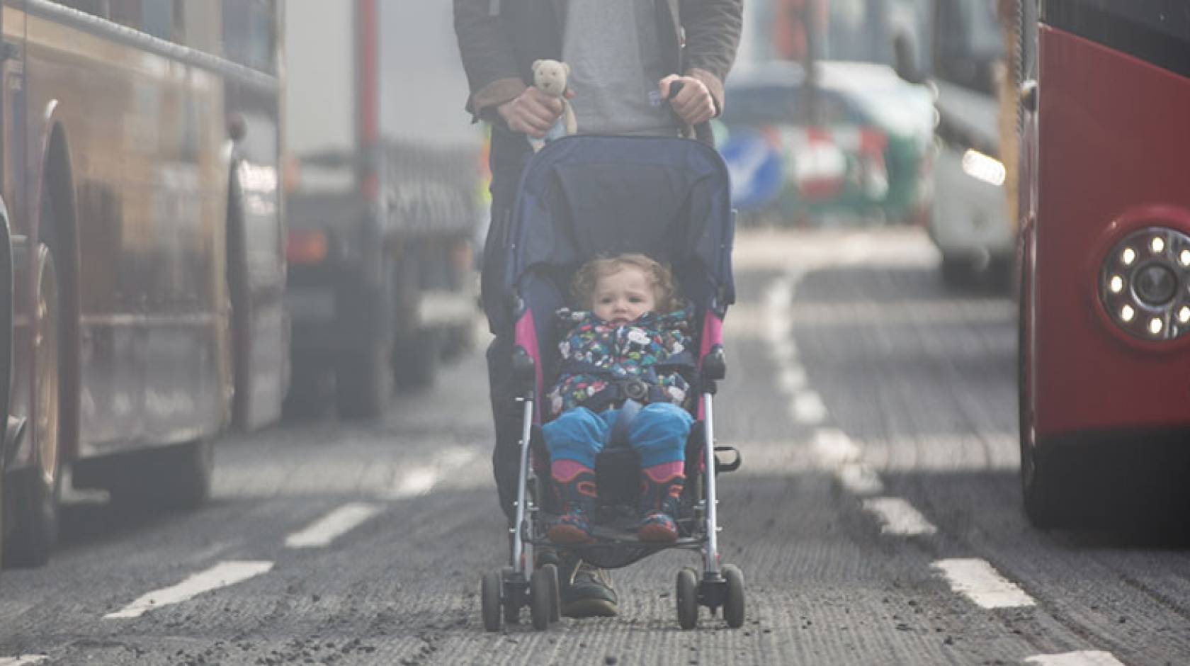 Child in stroller on a smoggy day