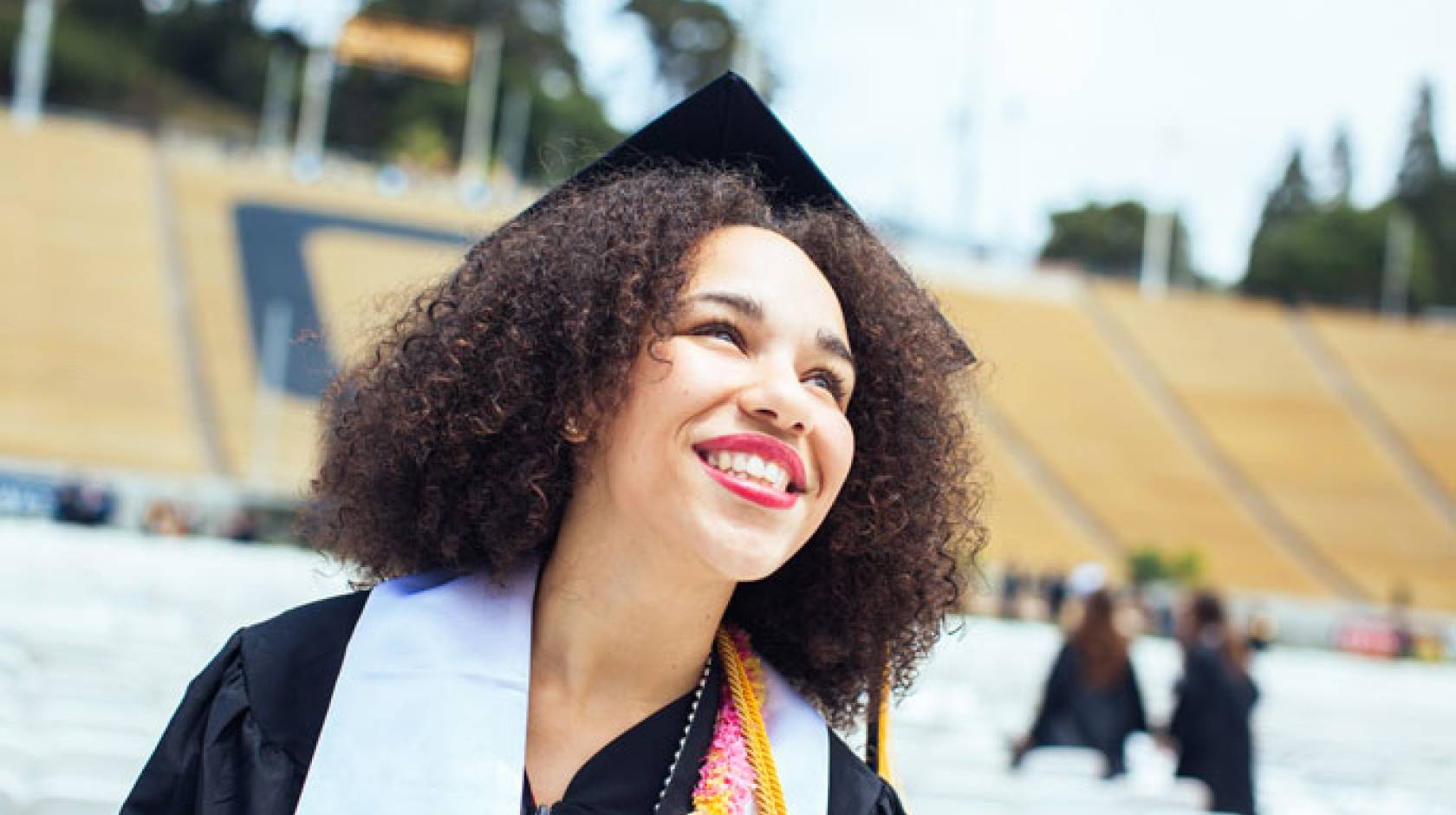 Happy young graduate in a stadium