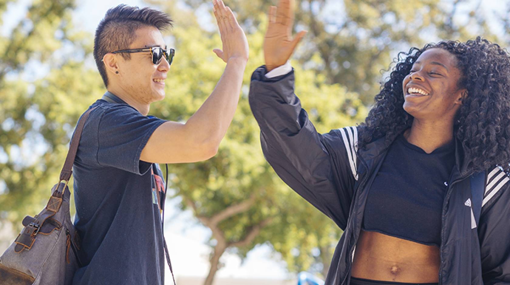 Two UC Davis students do a high-five