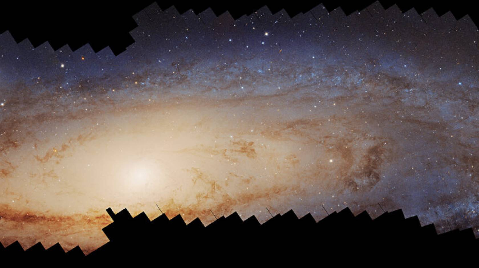 Glowing, swirling stars in a panorama: A photomosaic panorama of the Andromeda galaxy assembled over 10 years by the Hubble Space Telescope