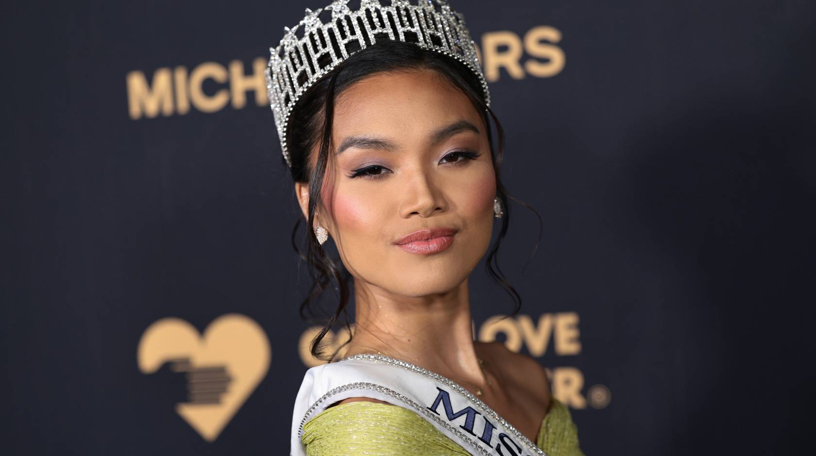 Young woman with a tiara, Marizza Delgado, poses at a Michael Kors event