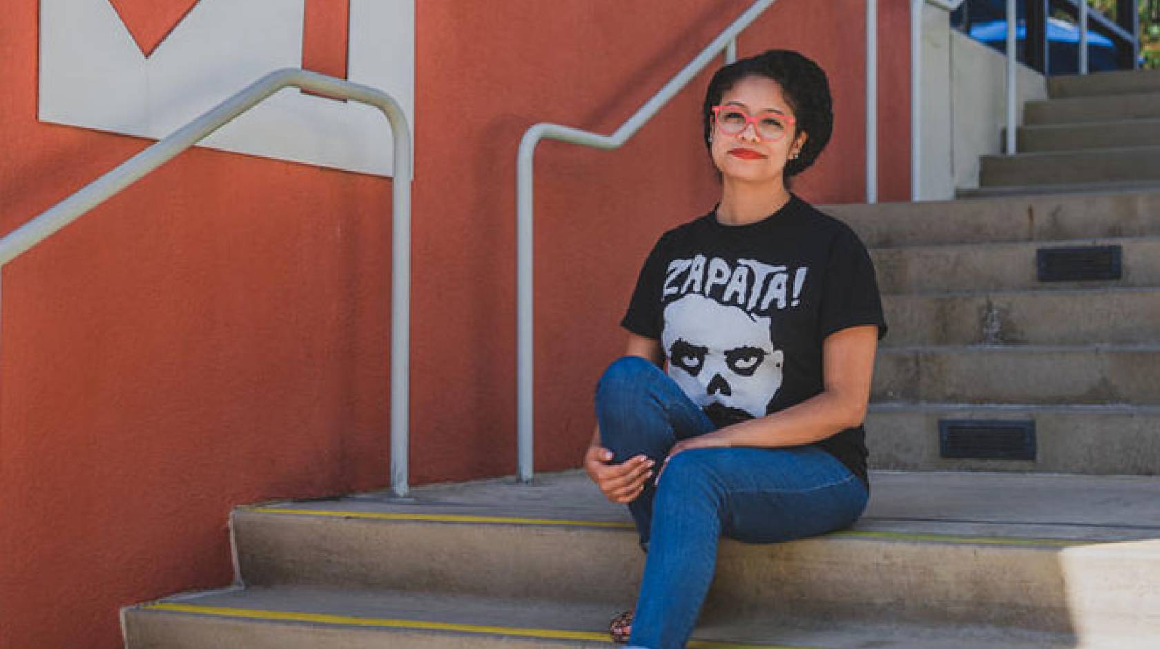 Marlen Ríos-Hernández sits on stairs