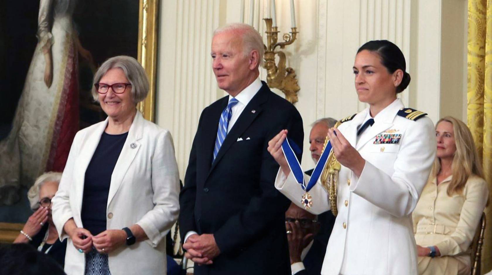 Sister Simone, President Biden and a woman in a Navy officer holding the Presidential Medal of Freedom