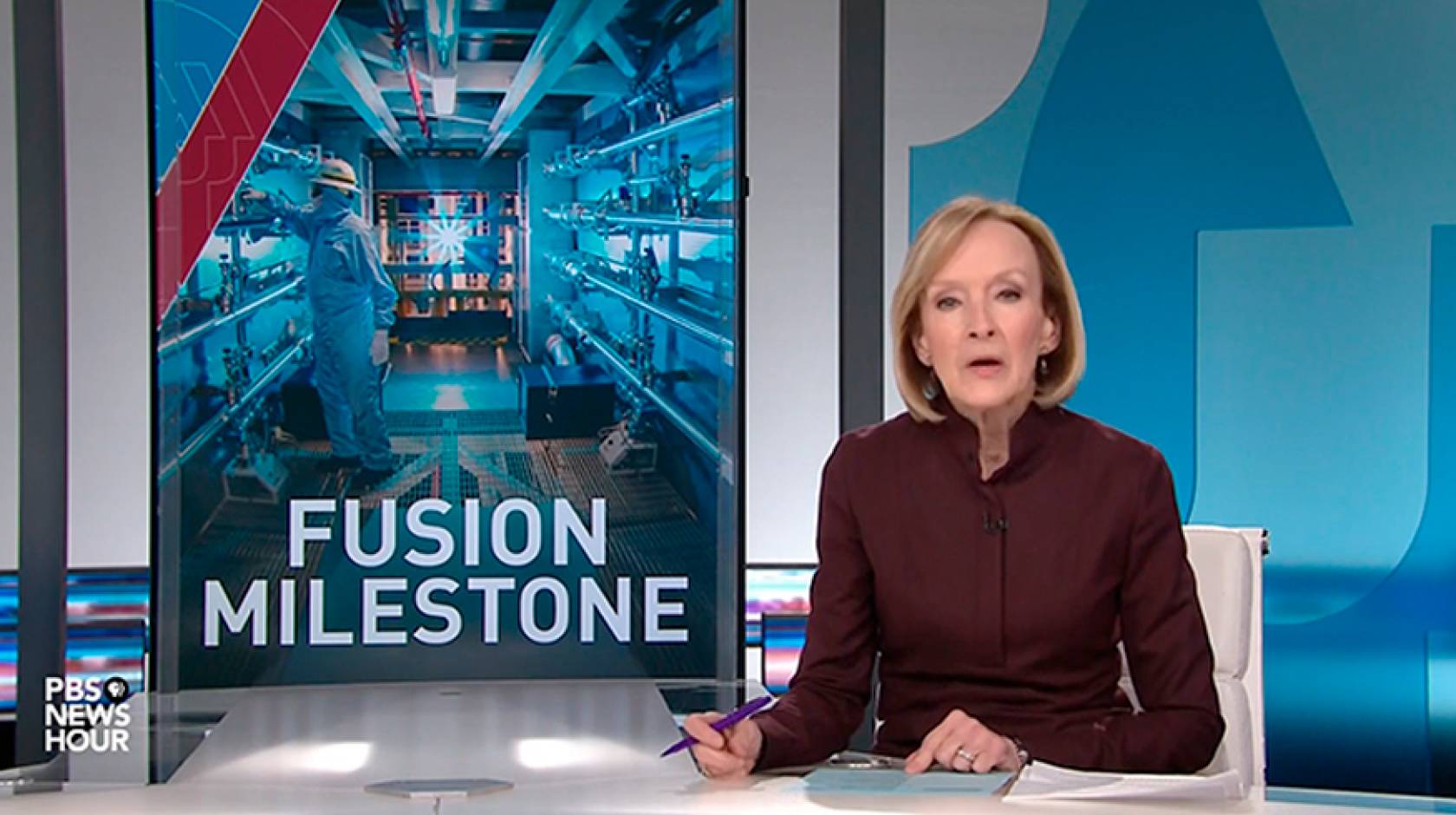 Anchor Judy Woodruff at the desk, with a graphic about fusion ignition on the side