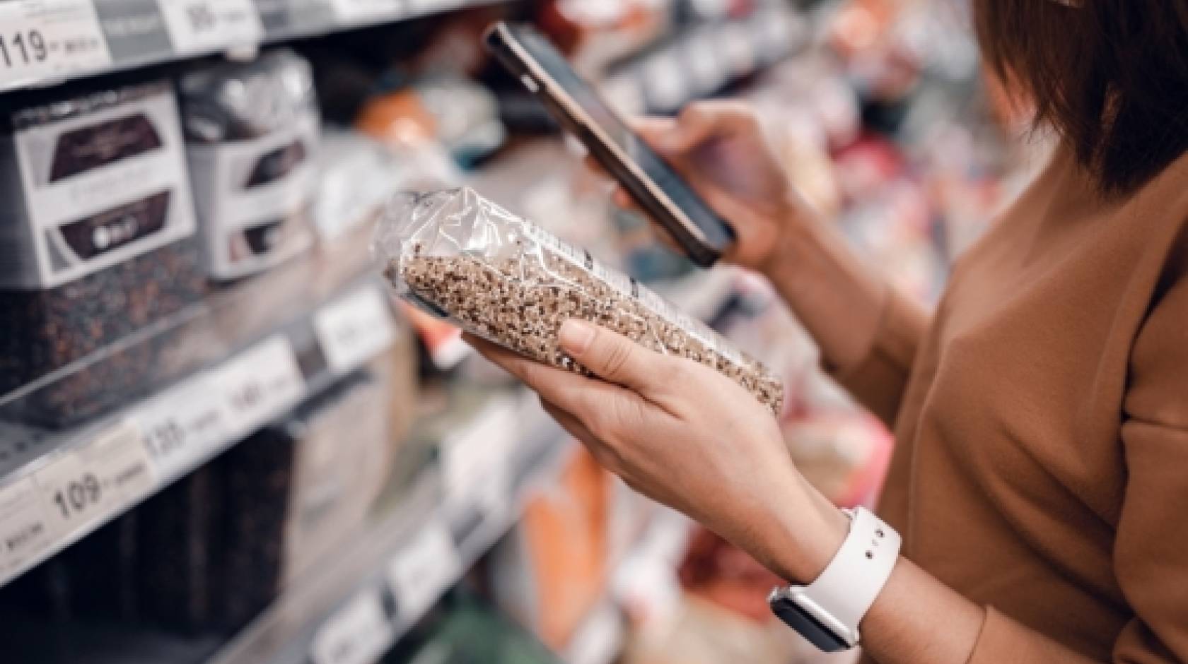 A woman looking at a nutrition label in a store