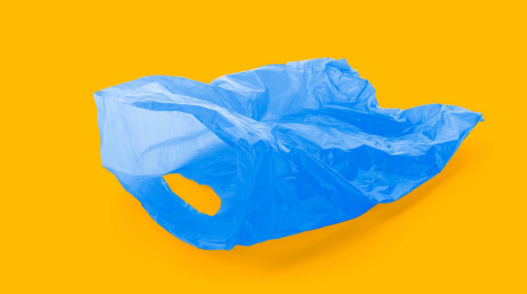 Blue plastic bag on gold background