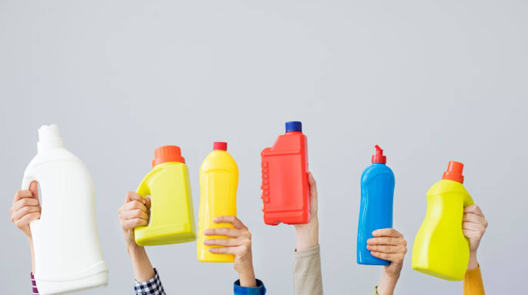 Hands holding up plastic bottles