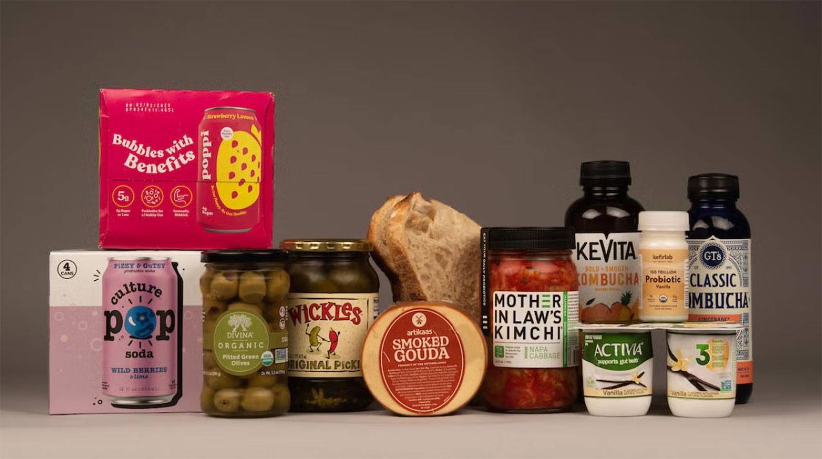 An arrangement of probiotic grocery products on a gray background