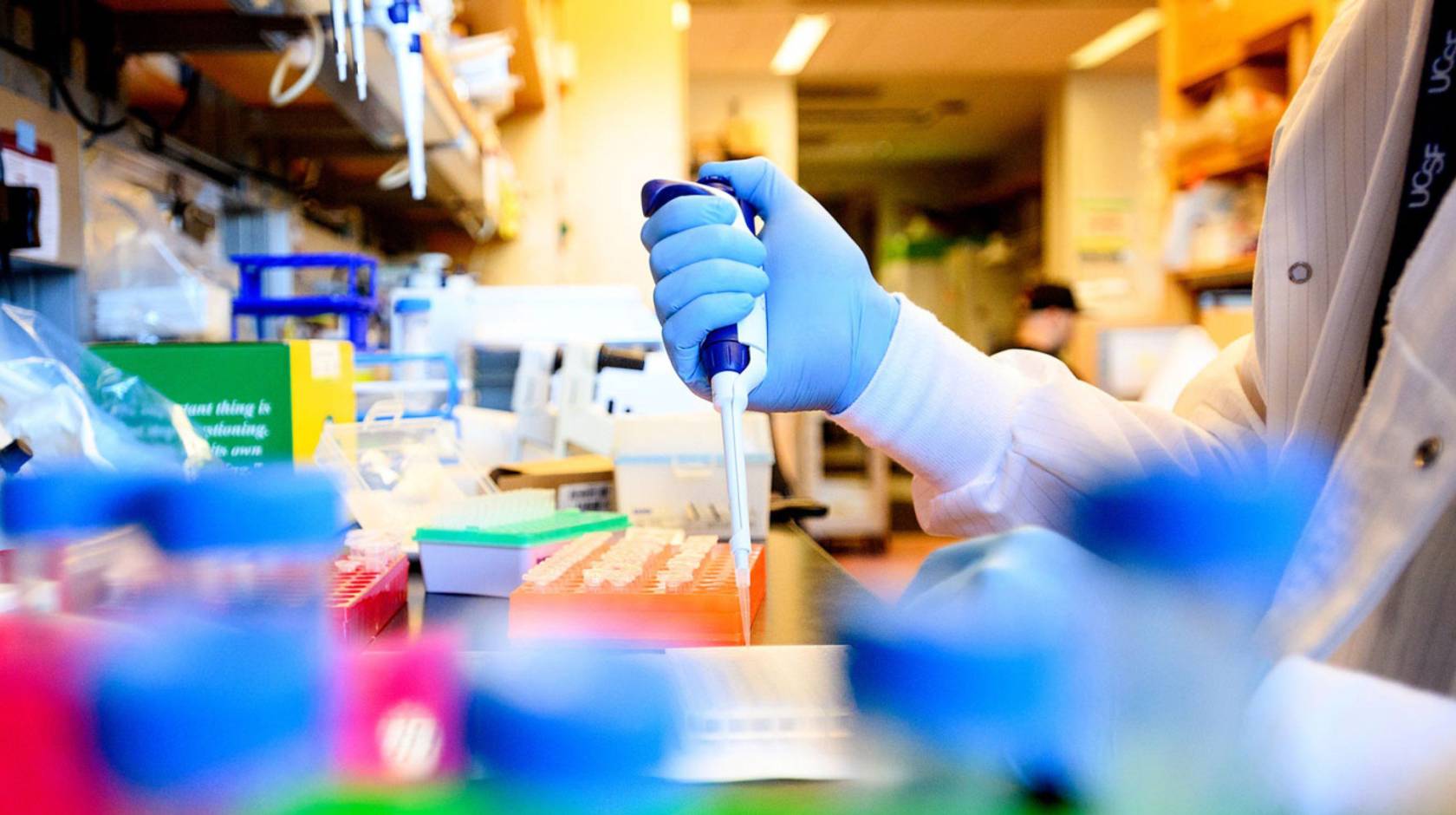 Person's hand using equipment in a lab