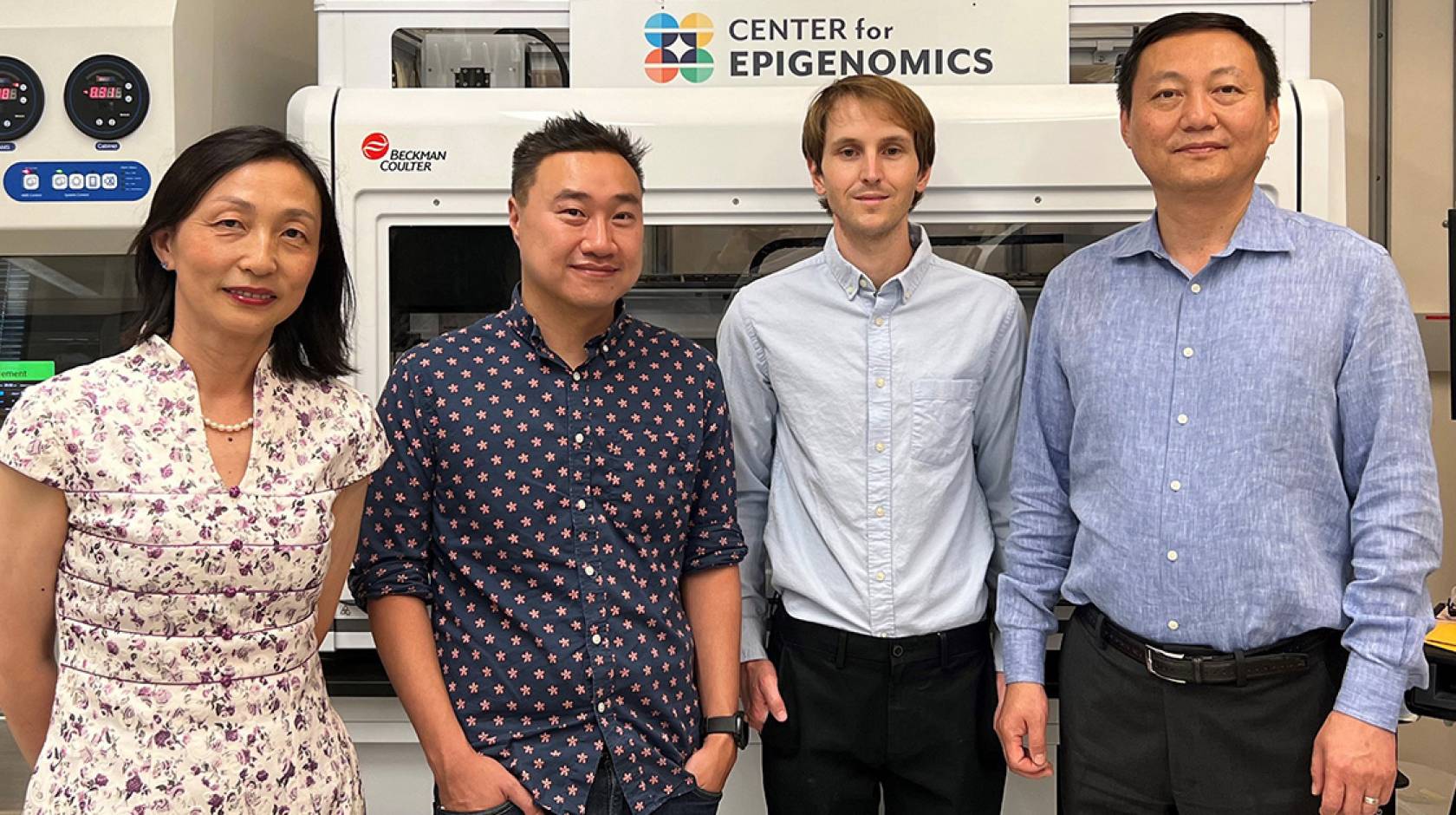 Four scientists standing together, three men one woman