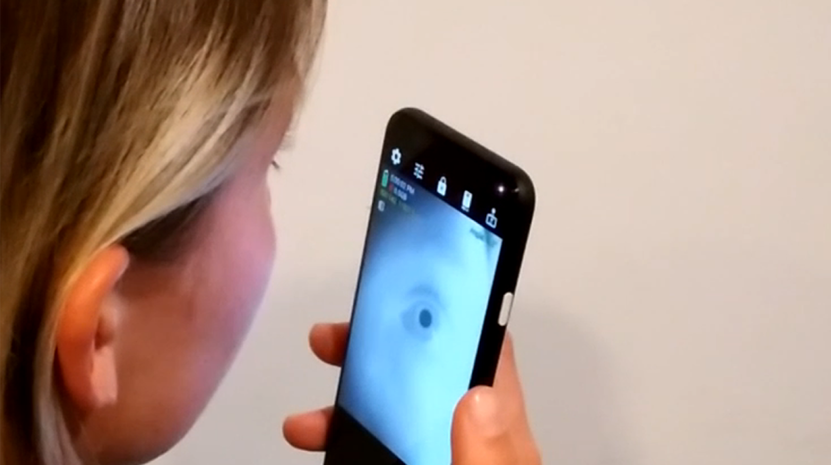 Woman looking into an app that shows her eye