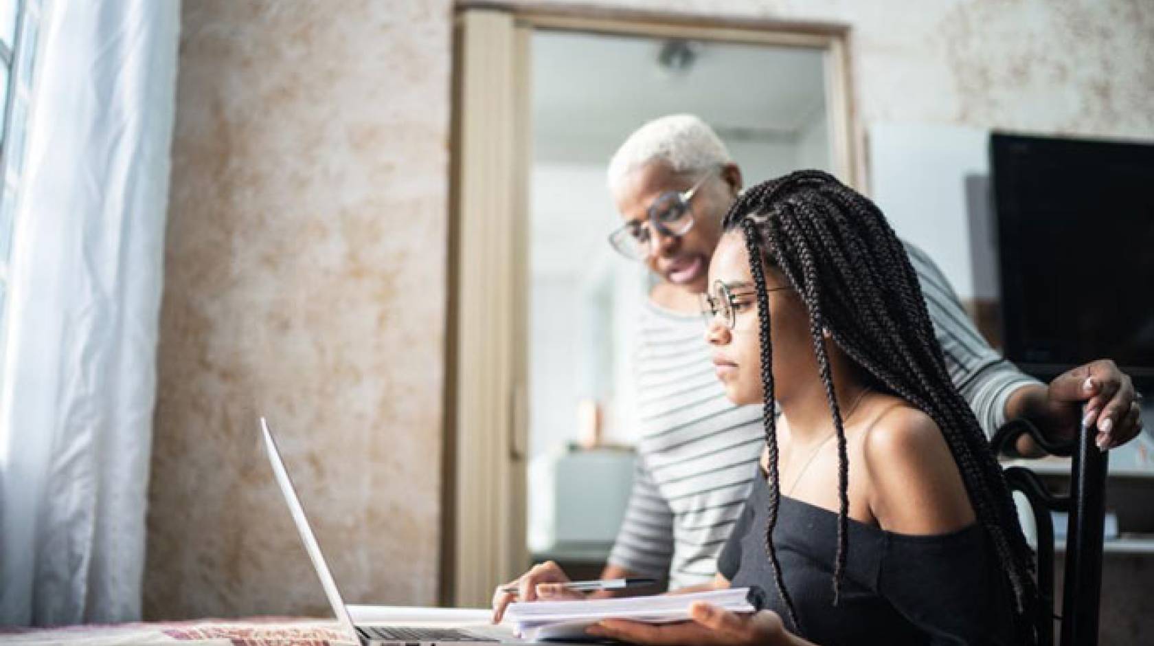 Student and grandparent looking at a computer