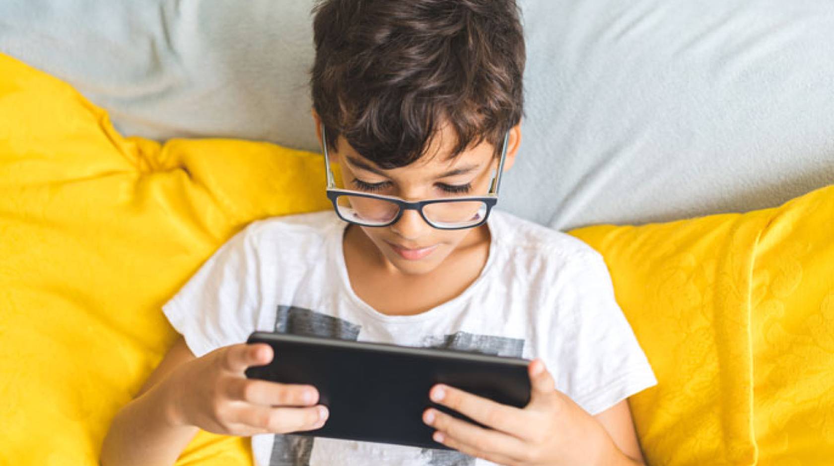 Overhead shot of young student learning on a tablet