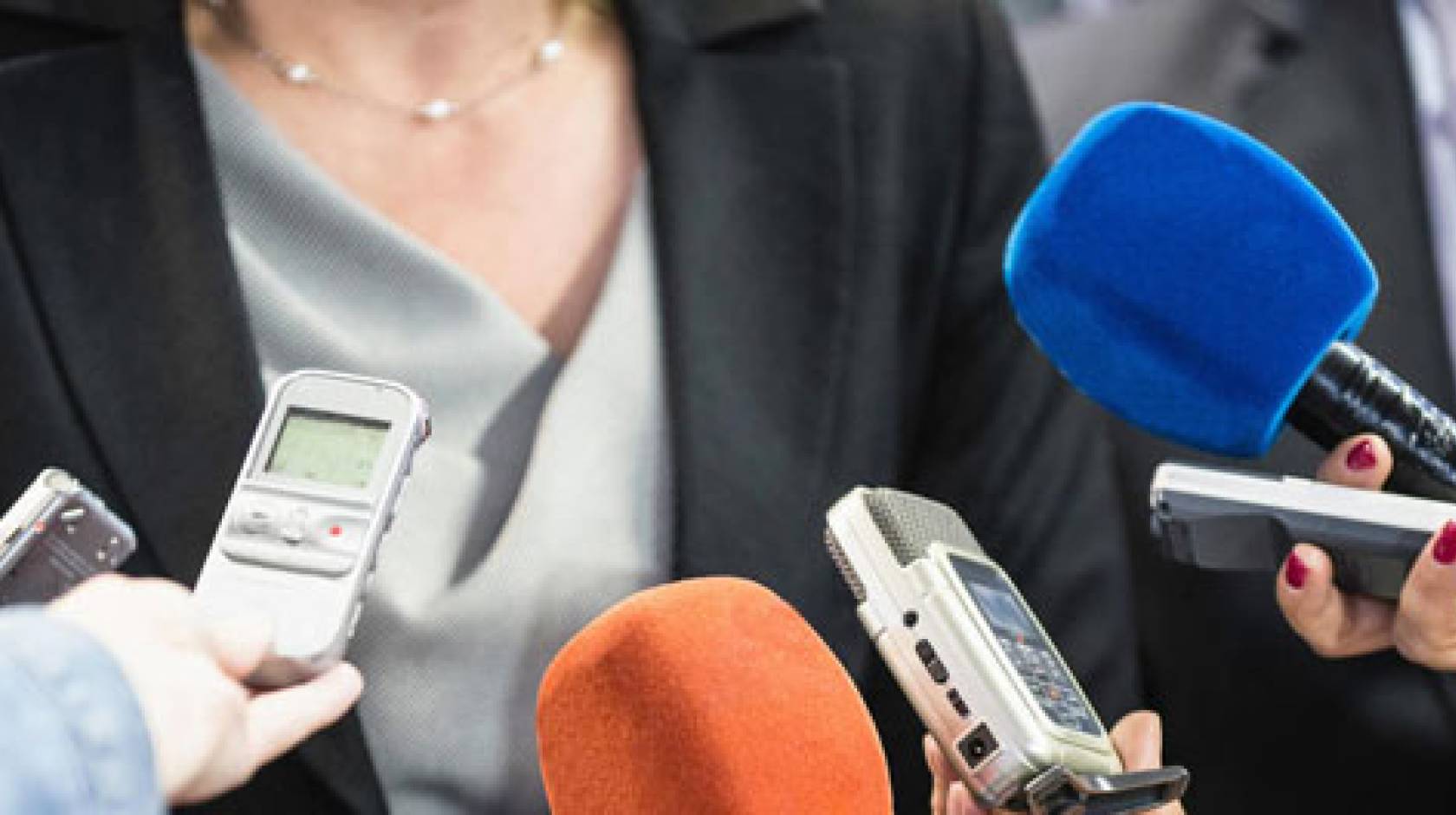 Mics held up to a woman