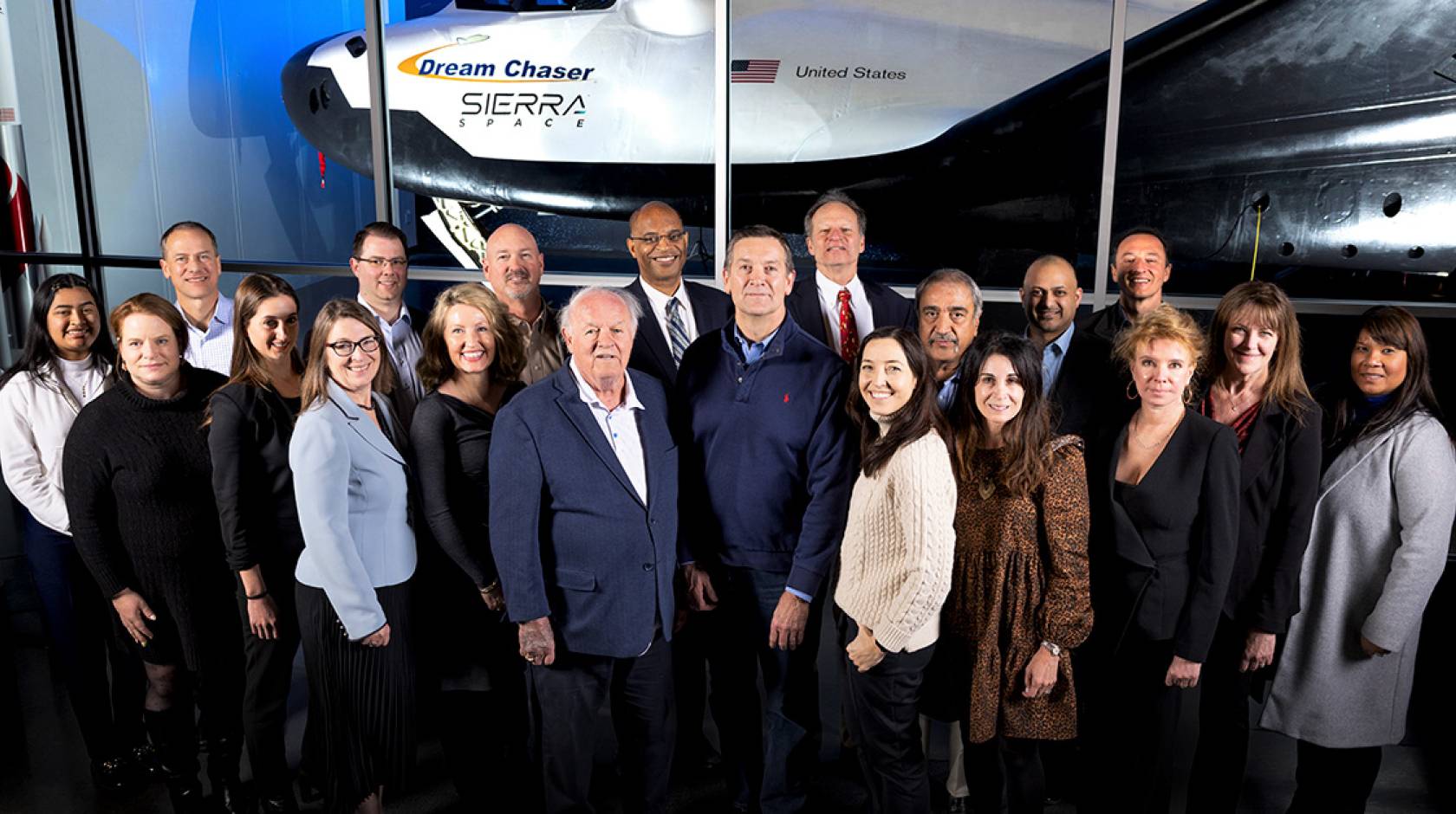 Group photo in front of a space vehicle