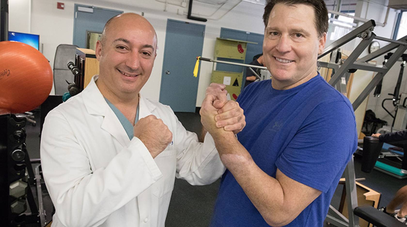 Dr. Kodi Azari, director of the UCLA Hand Transplant program, gets a good grip on Jonathan Koch's transplanted hand. Azari led the surgical teams that amputated Koch's hand and later transplanted a donor hand.