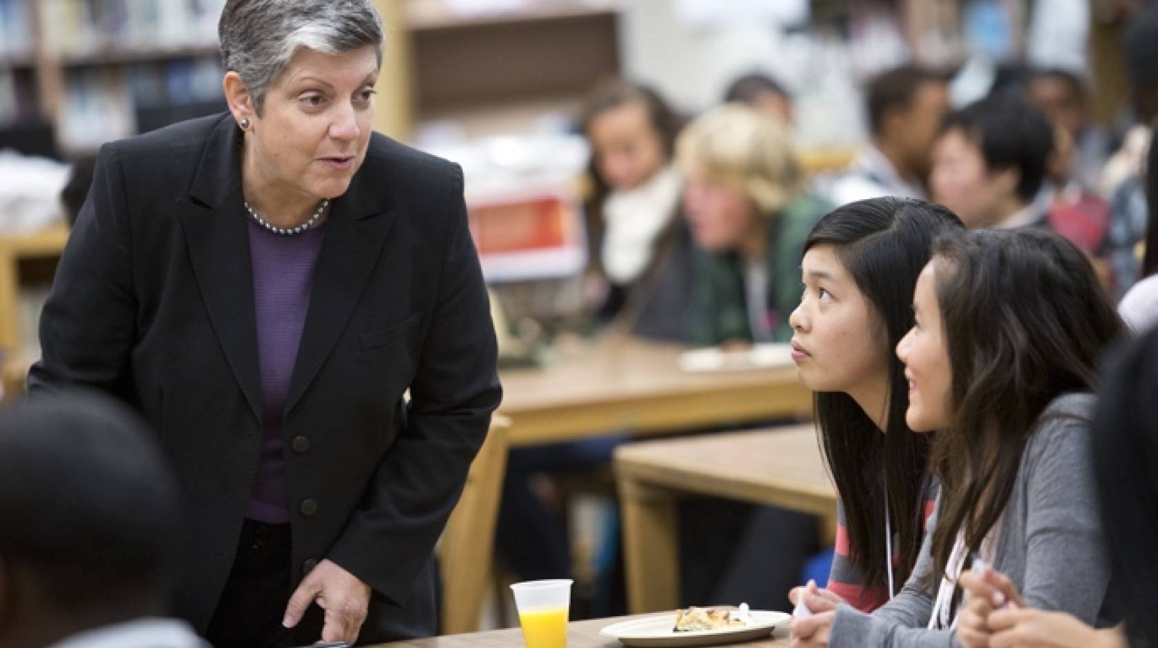 President Napolitano speaking to two students at Oakland Tech
