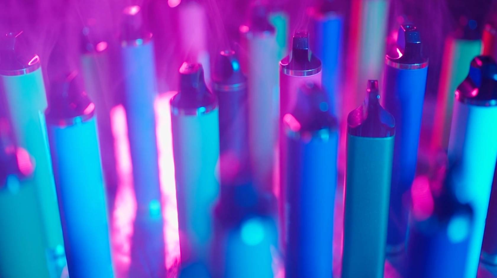 An array of vape pens in purple light