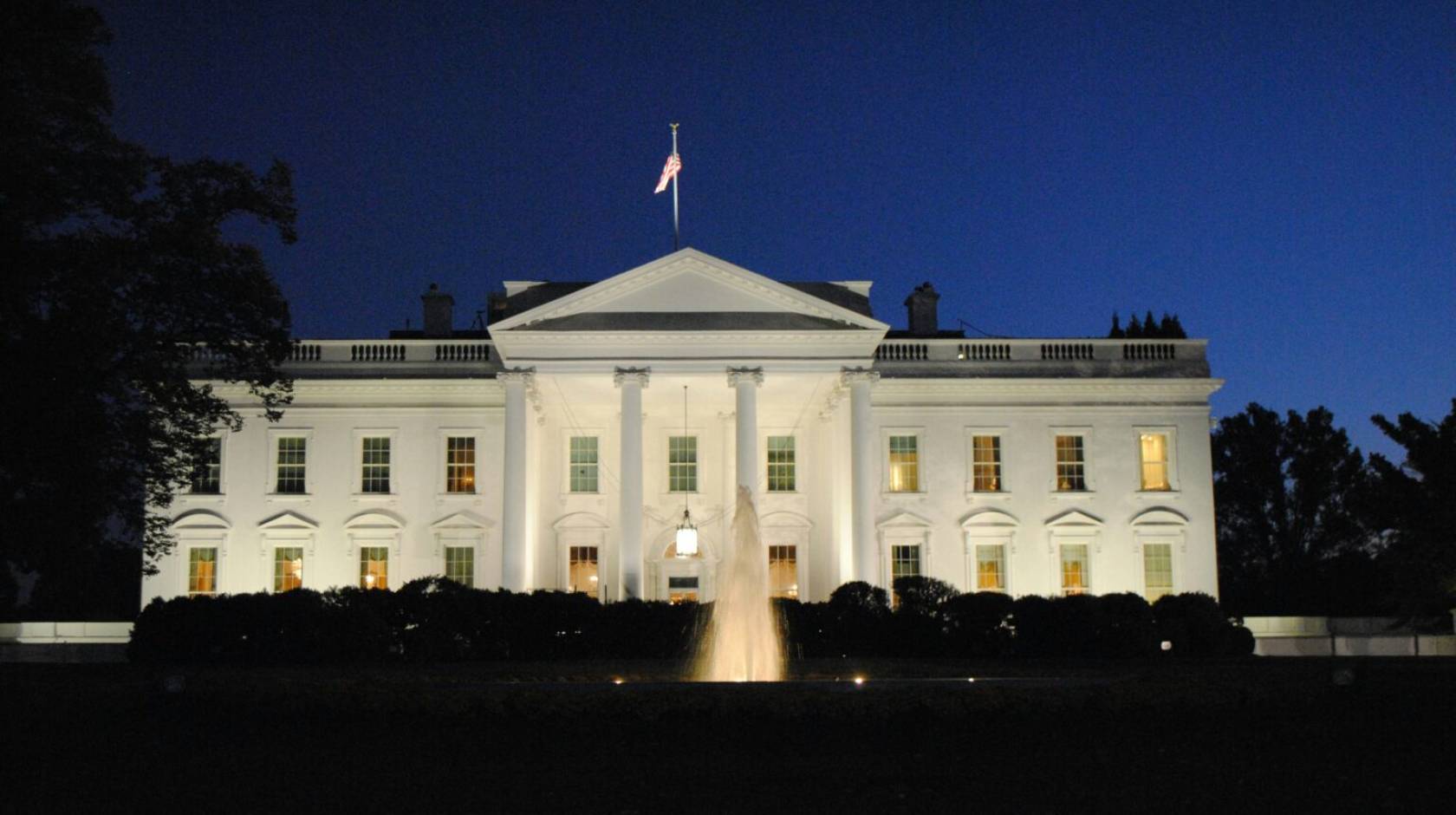 The front of the White House lit up at night