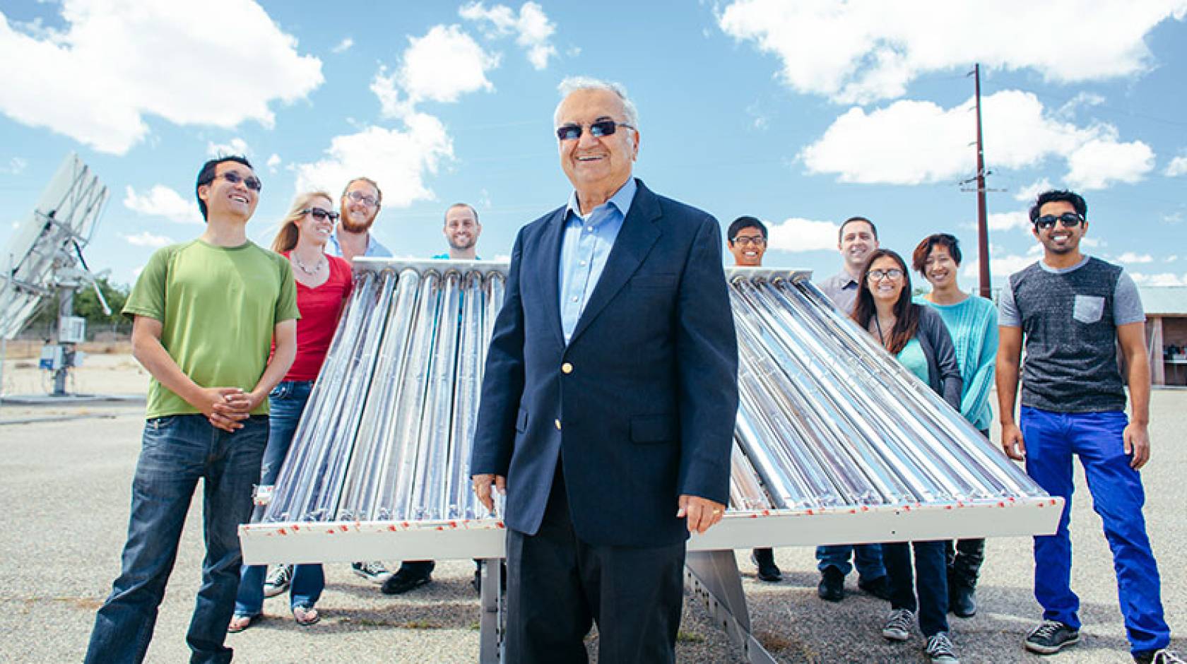 Professor Roland Winston and some of his student researchers and their solar collector. Winston in front