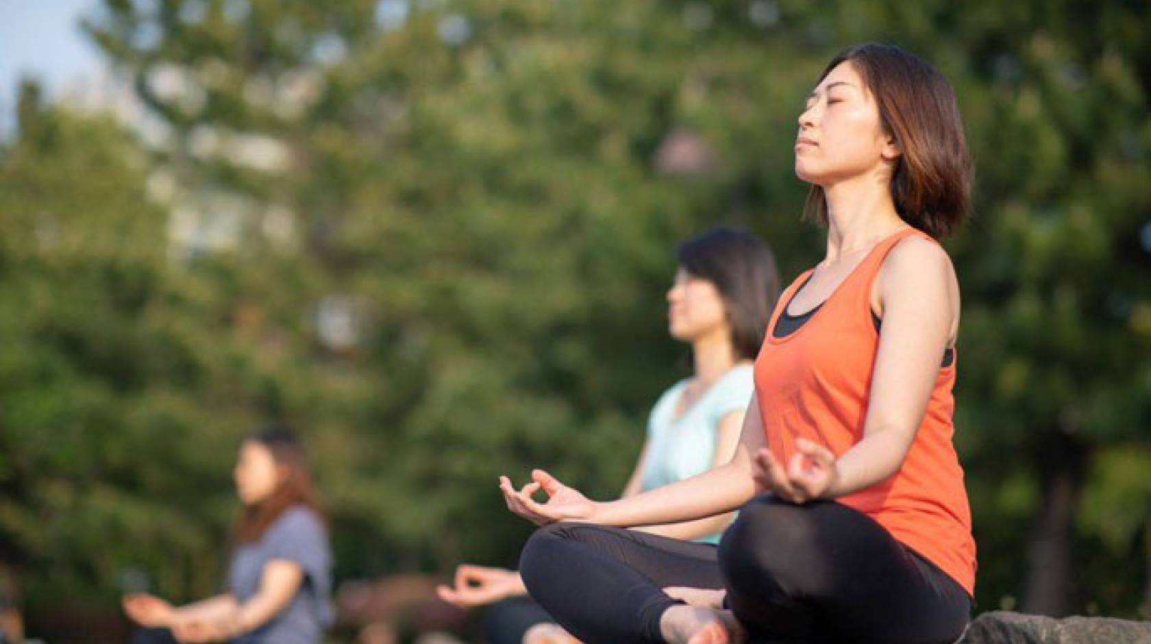 Women meditating outdoors