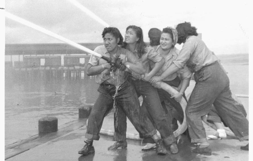 Women training with fire hose at Pearl Harbor Naval Shipyard.