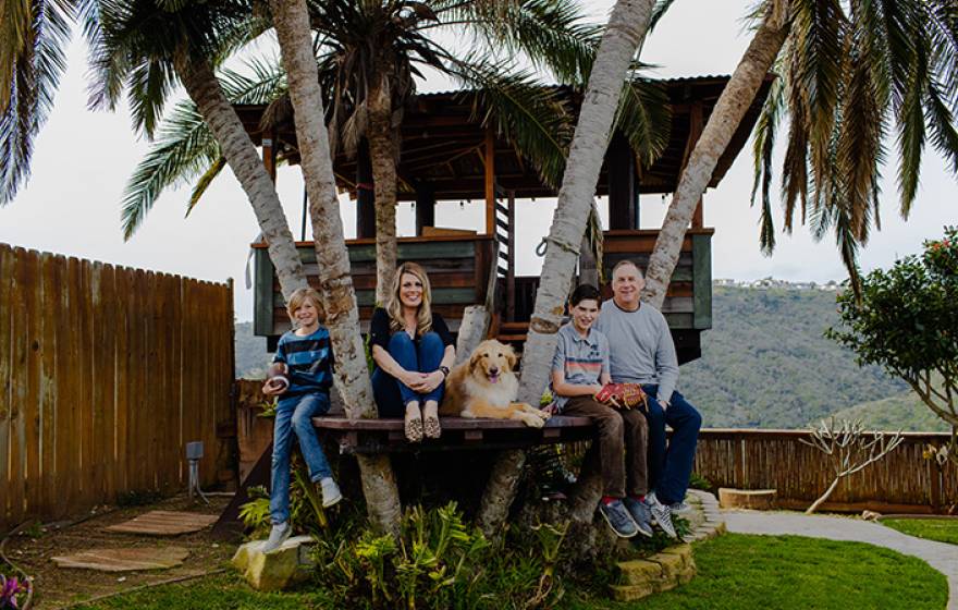 In remission after clinical trials A family of four, with a golden retriever, sits together in a treehouse