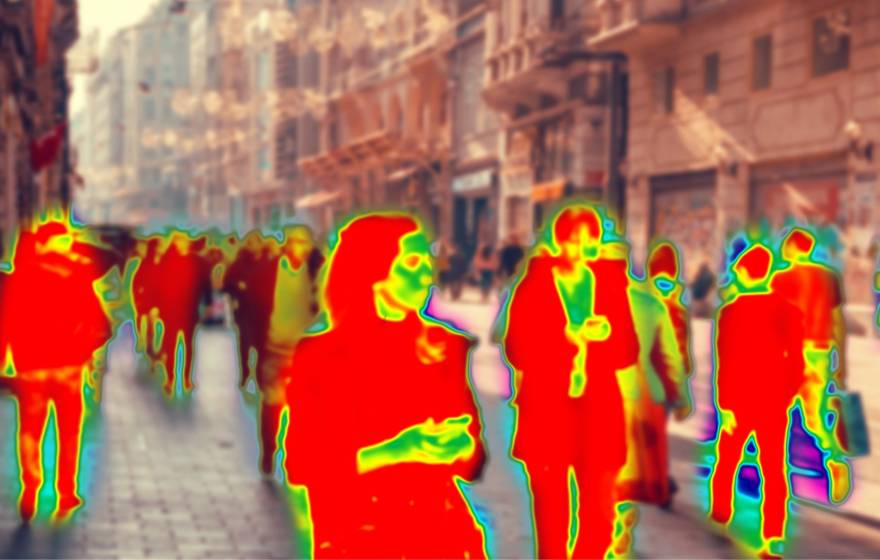 Pedestrians walking down a street, where the human figures are abstracted into red, yellow and green colors like a heat map