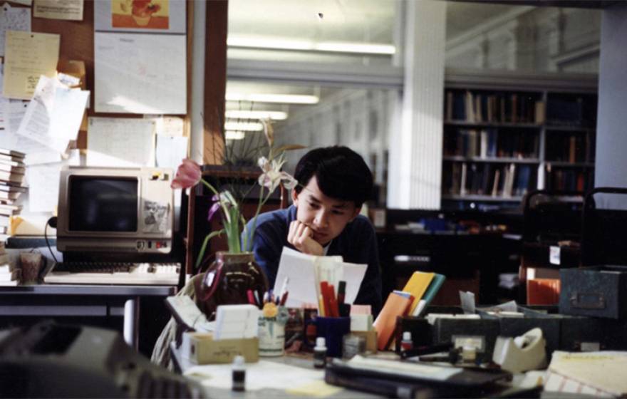 Viet Thanh Nguyen reading a paper in the library as a student at UC Berkeley