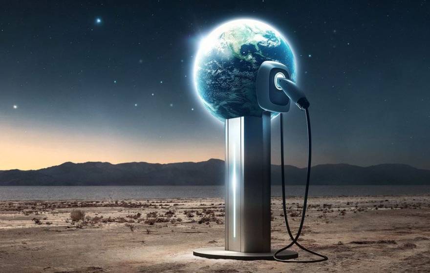 In a desert scene, an electric charger is plugged into a globe