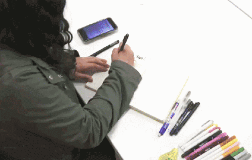 Frida writes in her notebook as captured in a time lapse