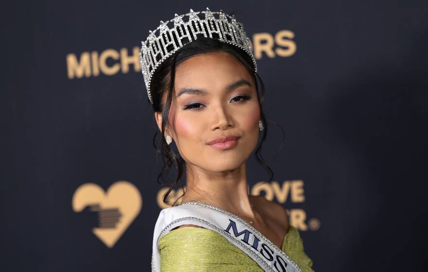 Young woman with a tiara, Marizza Delgado, poses at a Michael Kors event