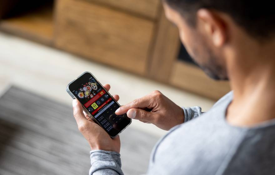 Man looks at gambling app on smartphone