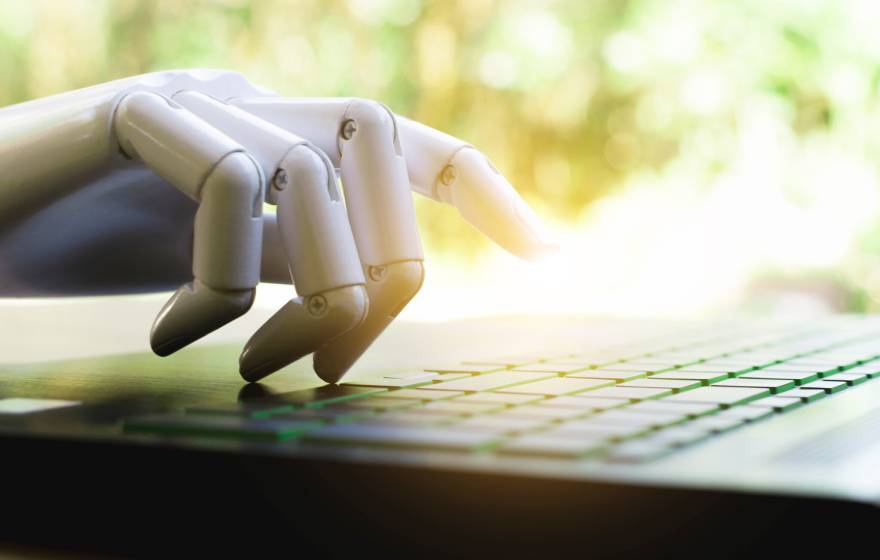 Robot hand on a computer in bright sunlight