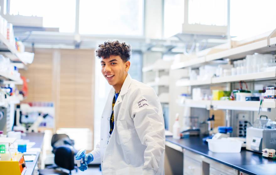 Young Black male researcher in UC lab coat