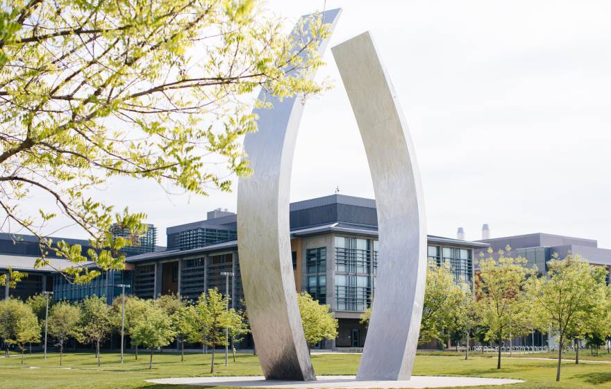 UC Merced campus A view of UC Merced's campus with the sculpture, Beginnings, gently curving, vertical stainless steel arms, each about 40 feet high, in the center