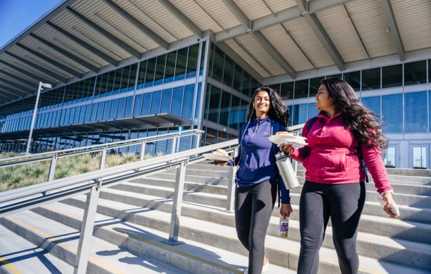 Two students walk out of the Pavilion dining center on the UC Merced campus