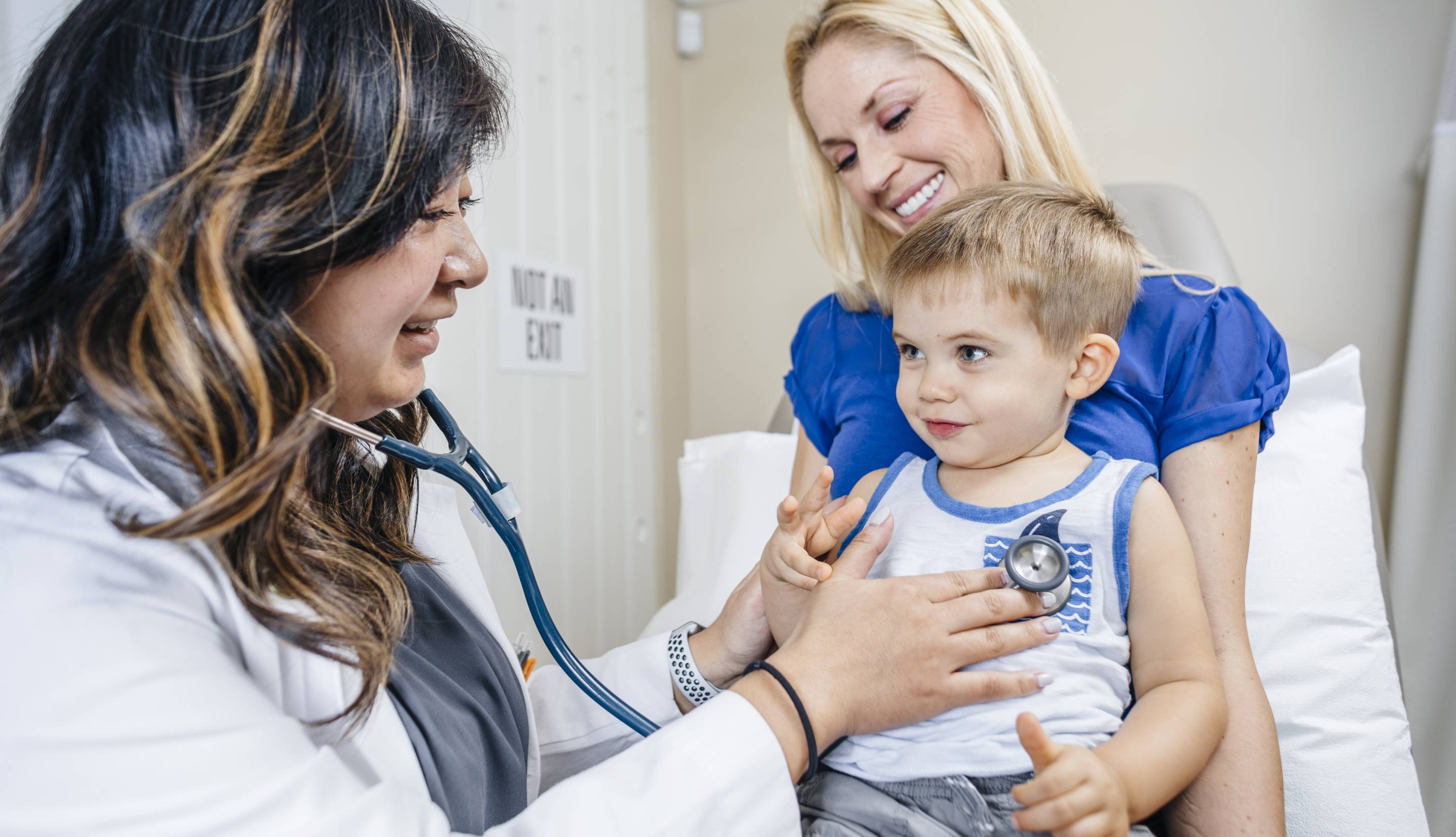 Doctor listens to a little boy's heart