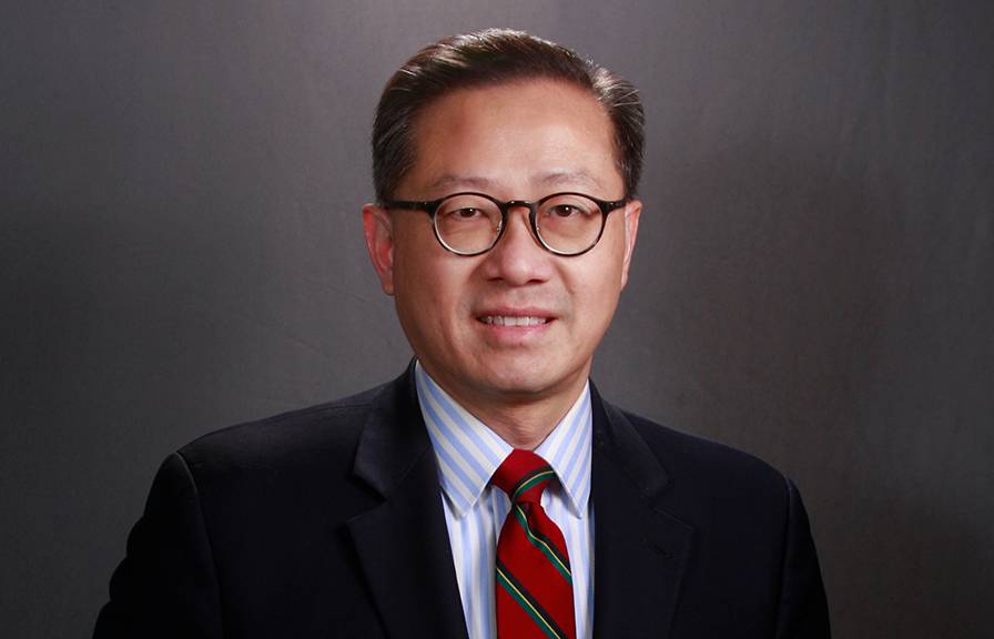 Dr. Steven W. Cheung -- middle-aged man with well-combed dark hair and glasses in a suit with red tie