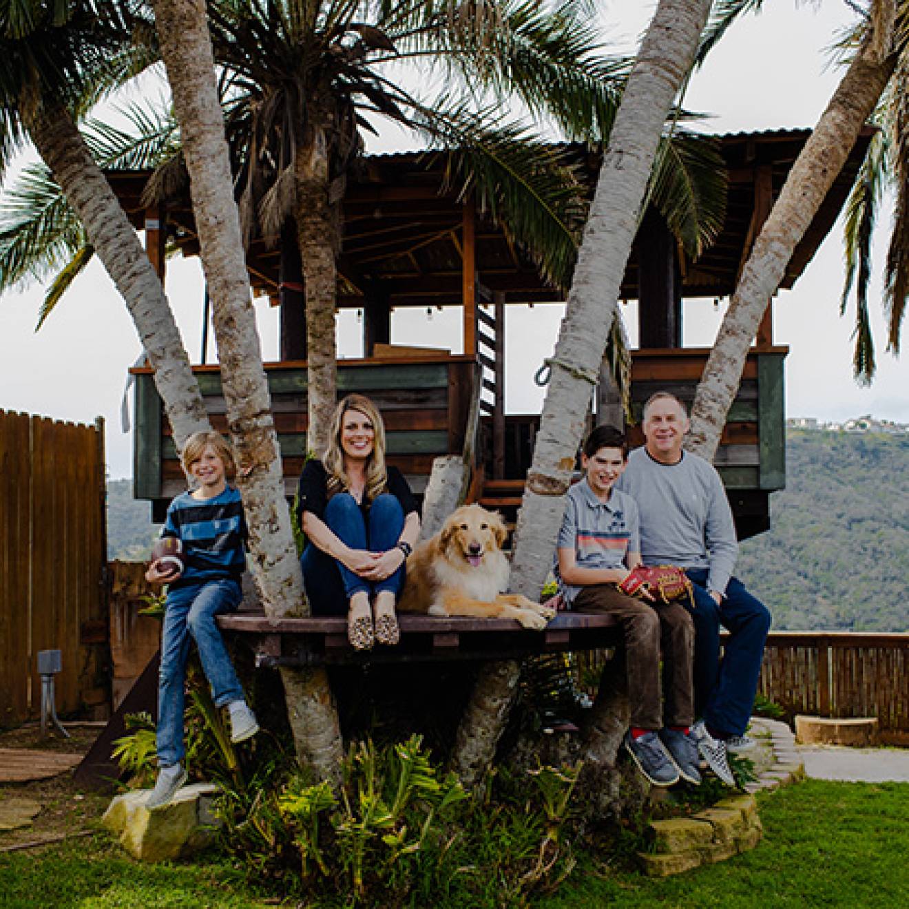 In remission after clinical trials A family of four, with a golden retriever, sits together in a treehouse