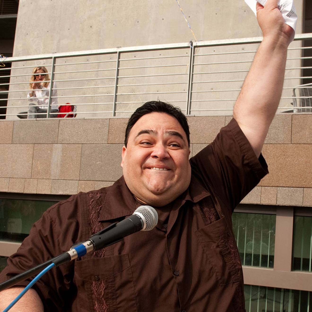 Marco Angulo raises his fist in the air triumphantly, clutching a piece of paper