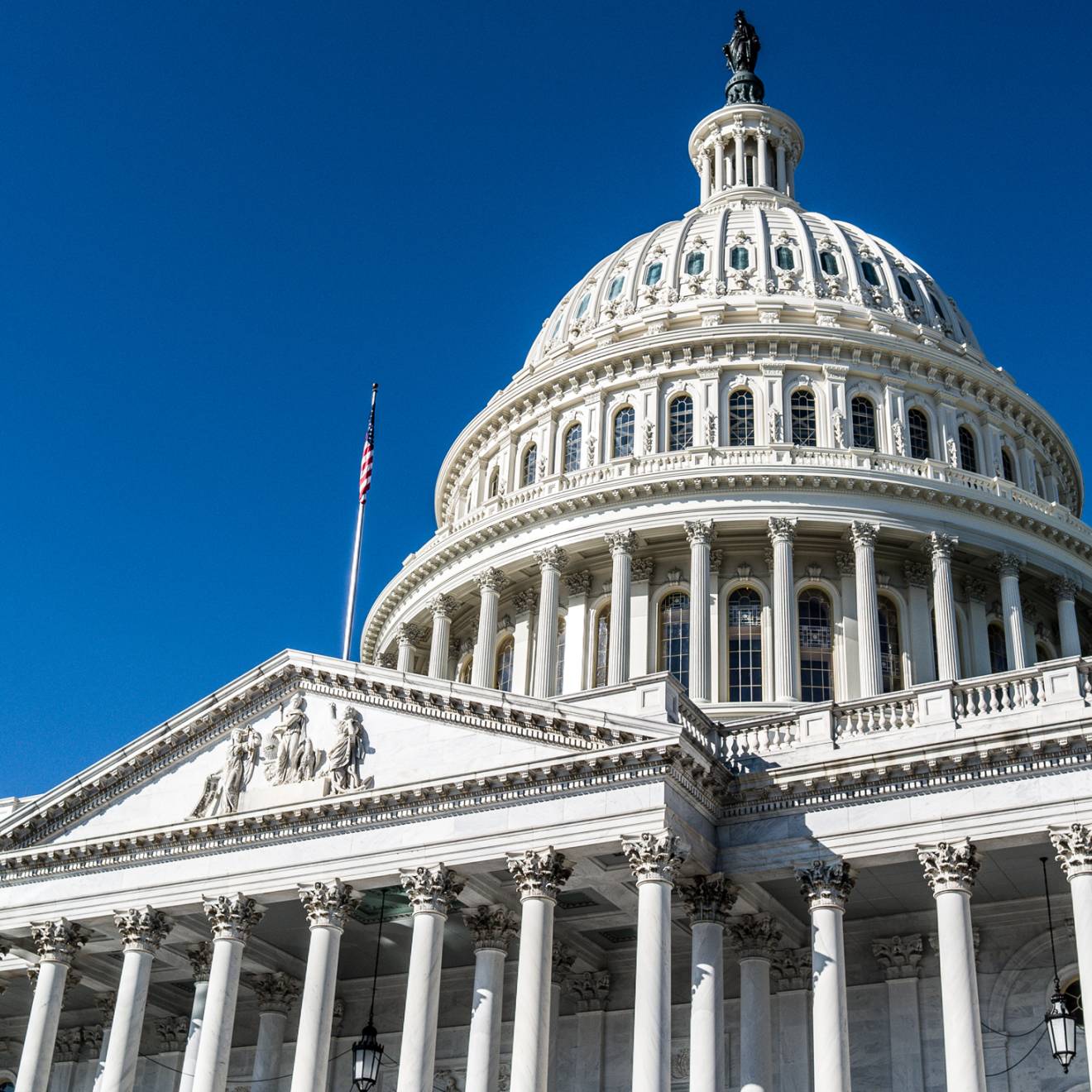 H.R. 1 bill The U.S. Capitol building viewed from an angle against a bright blue sky