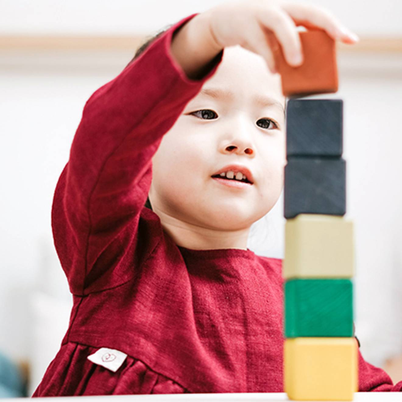 Young child playing with blocks in a classroom