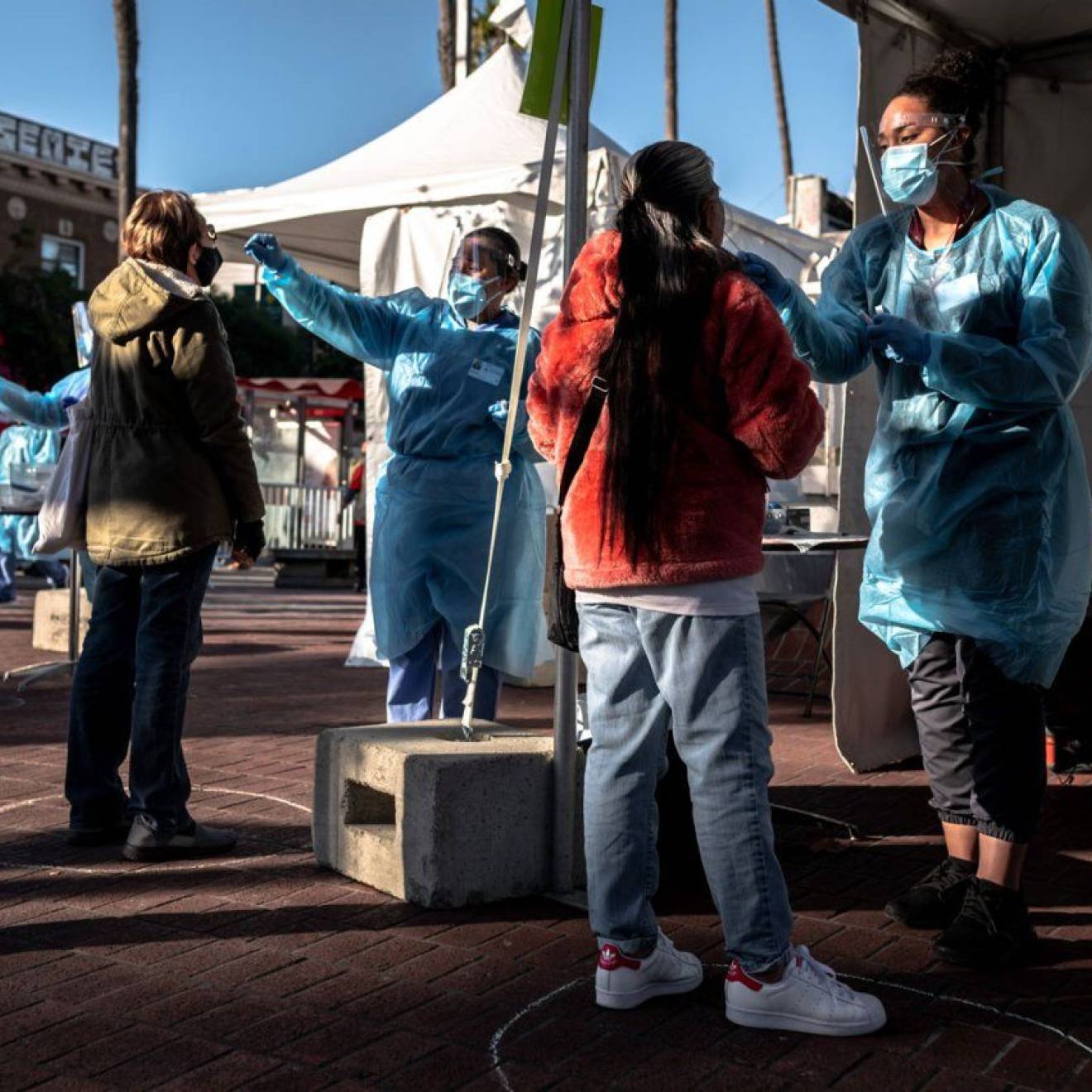 Mission residents are swabbed for COVID-19 at a pop-up, test site at the 24th St. Mission Bart Station