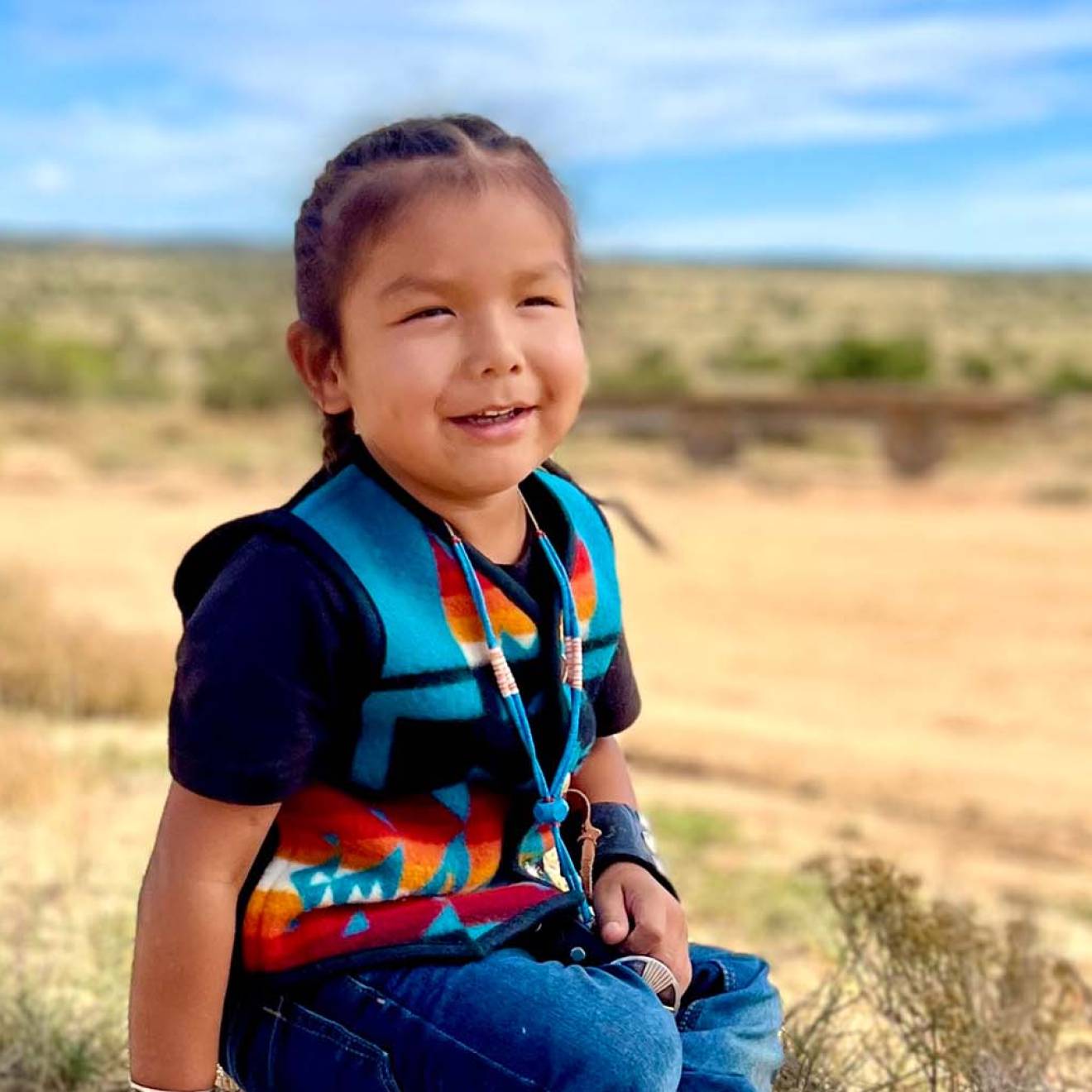 HT, a Navajo toddler, smiling at home