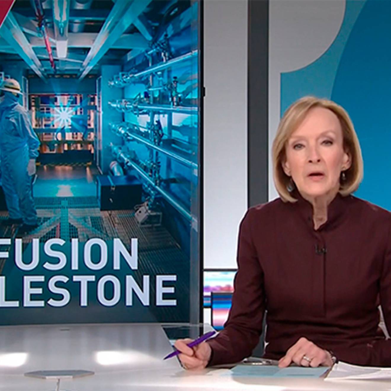 Anchor Judy Woodruff at the desk, with a graphic about fusion ignition on the side